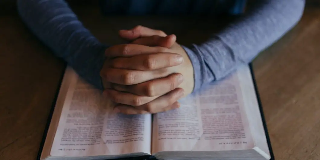woman studying bible and praying