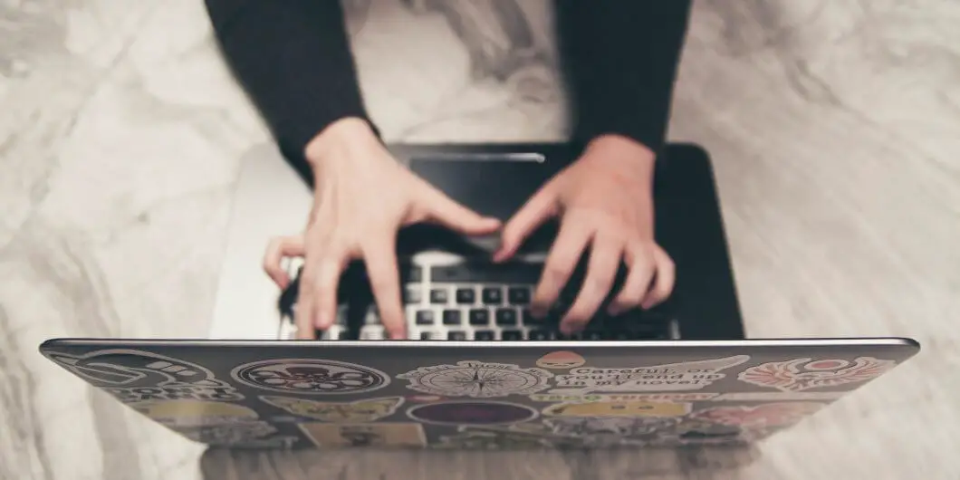 woman sitting at computer black shirt