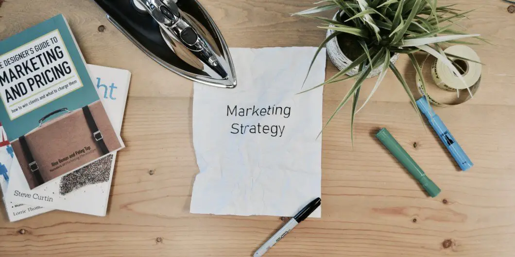 white paper on a desk with marketing strategy written on it